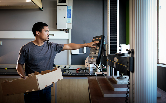 Cashier holding corrugated carton box